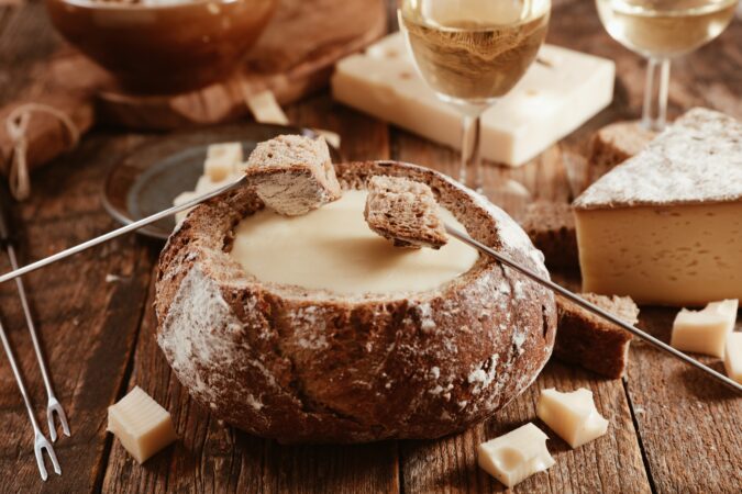 Traditional Swiss cheese fondue with wine glasses